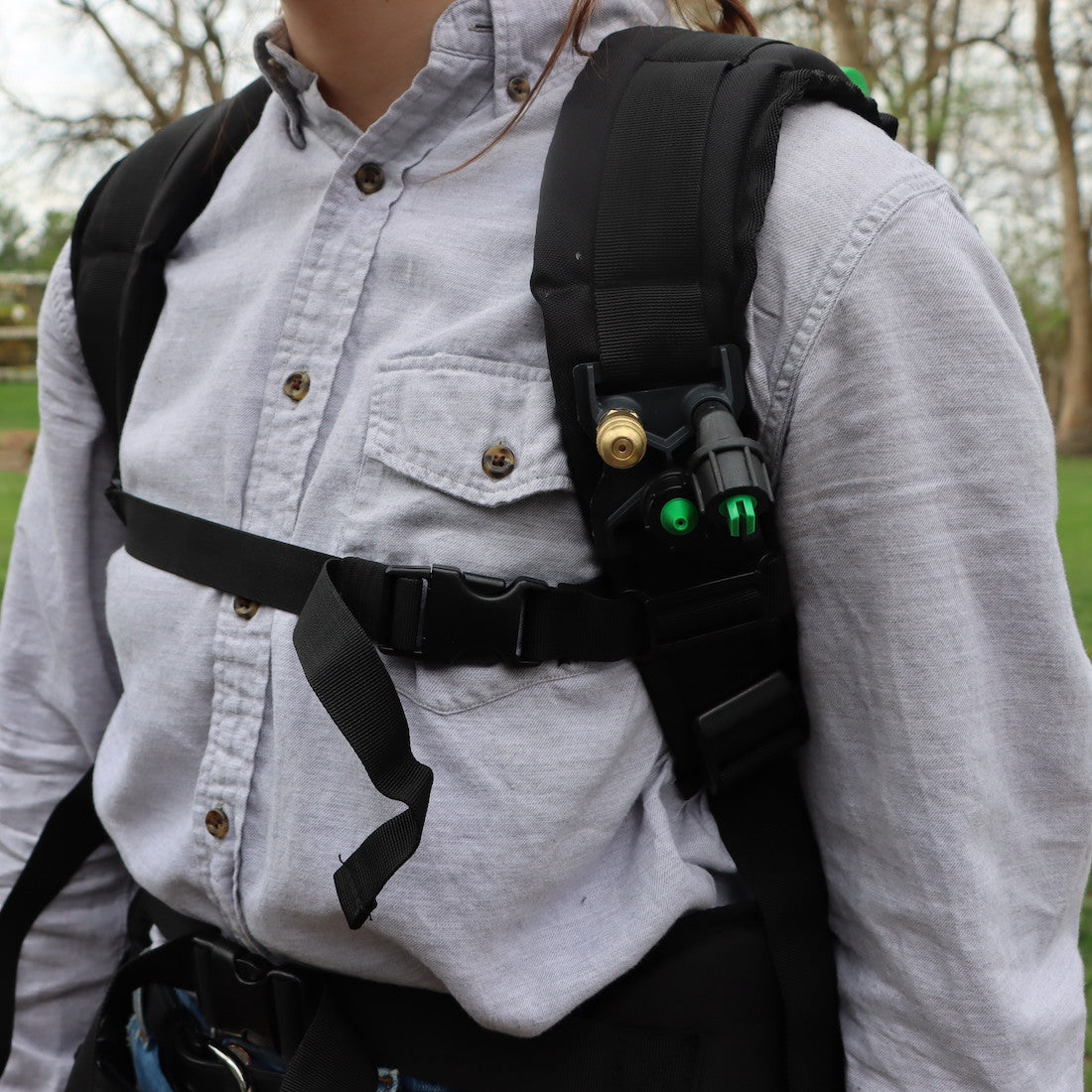 woman with backpack straps and nozzle holder