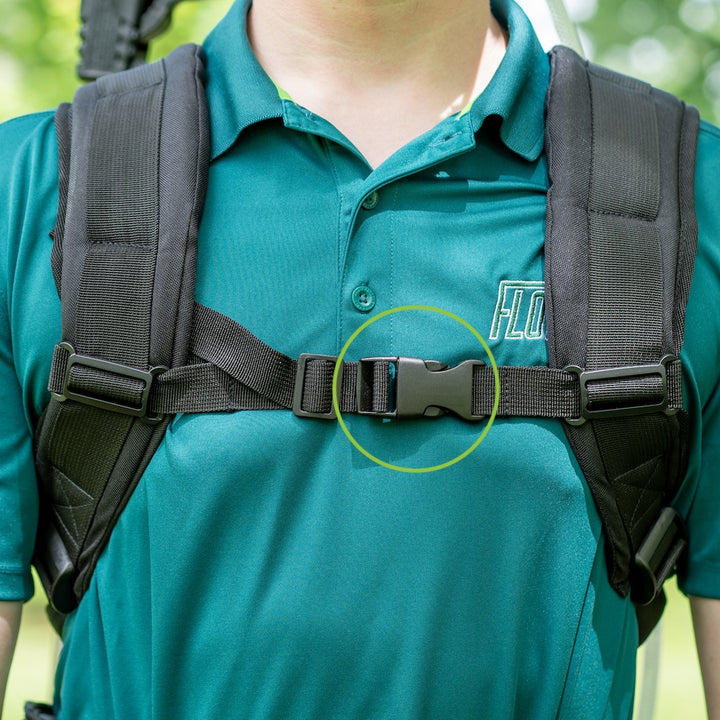 Person wearing a green shirt with black comfortstraps, focusing on the buckle.