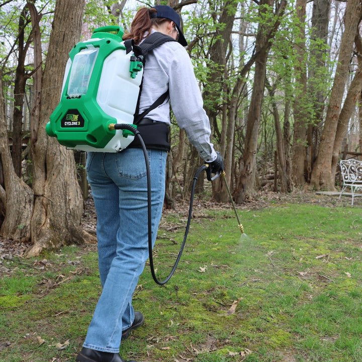 woman spraying yard with flowzone backpack sprayer