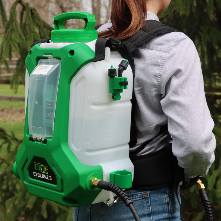 woman standing in front of tree wearing flowzone backpack sprayer